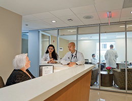 Doctors talking to a receptionist. Links to Beneficiary Designations