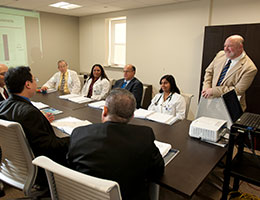 Photo of staff talking. Links to Tangible Personal Property.